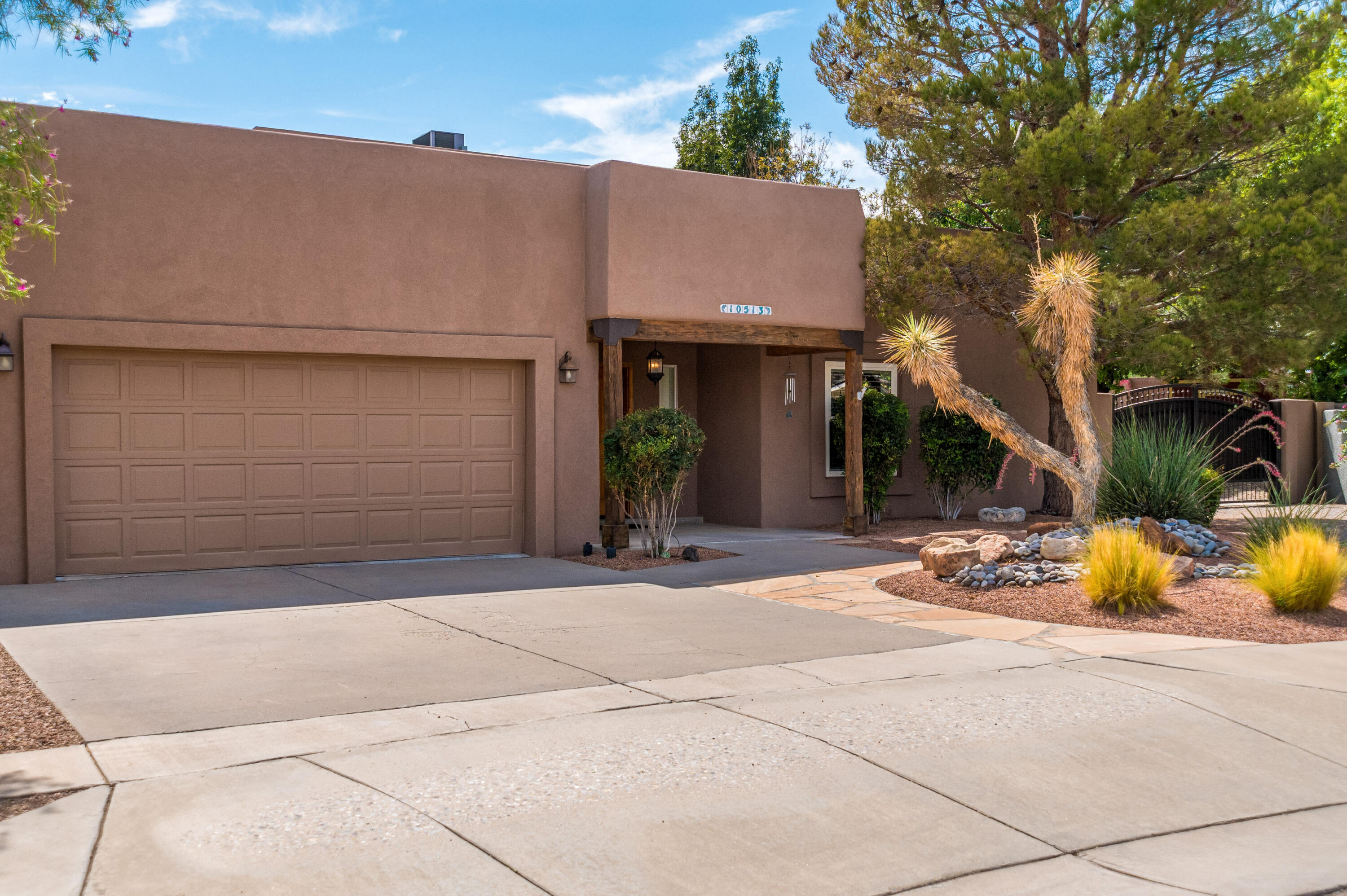 Tucked away on a cul-de-sac in a desirable NW location, this five-bedroom, three-bathroom home offers space, style, and flexibility at every turn. The great room welcomes you with soaring ceilings and a custom fireplace, flowing seamlessly into a chef's kitchen designed for both everyday living and entertaining. A formal dining area, spacious den, and dedicated bar round out the main living spaces, offering plenty of room to gather. No carpet! The main floor is home to a private primary suite with direct outdoor access, along with two additional bedrooms, while two more bedrooms and a full bathroom occupy the upper level, offering ideal separation for family or guests.For hobbyists, entrepreneurs, and car and toy enthusiasts alike, this property delivers. Beyond the attached two-car garage, a 1000-square-foot insulated detached two-car RV garage with a workshop area provides exceptional space for projects, and storage. Wide driveways and ample RV and trailer parking add even more versatility. NO HOA!Outdoors, covered patios invite relaxed entertaining or quiet evenings, while a storage shed, custom gates,  beautiful flowers, and towering trees, create a peaceful, established setting.Recent updates throughout the home including stucco, kitchen, bathrooms, flooring, dual refrigerated air conditioning, water heater, and backyard landscaping, make this property truly move-in ready!
