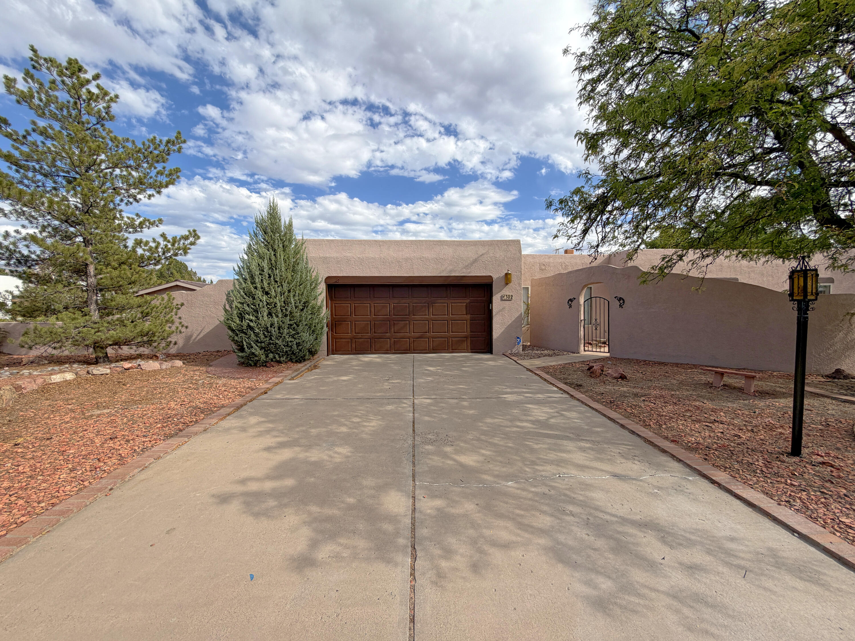Custom built home - Partial Frame and Stucco, Partial Adobe Block. Best overlook view of Corrales and Sandia Mountains. Good sized lot. Rear gate access to walking trails.  Lots of wood insets inside and out.  Sunken sitting area around fireplace in Living Room, with second fireplace access in Primary Bedroom.  Copper bath sink. Primary has Black Clawfoot tub and separate shower.  Private garden off Primary Bath.