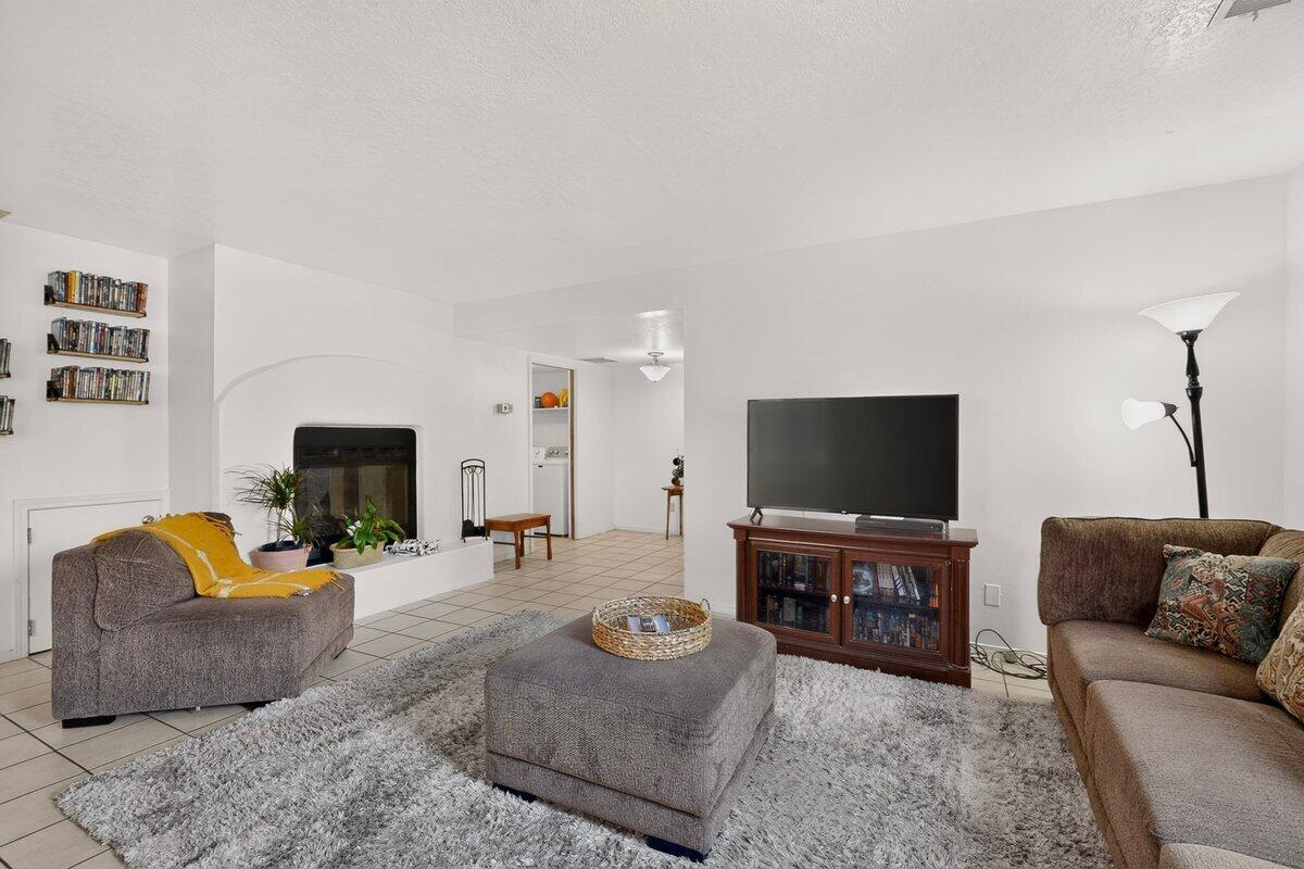 Low maintenance two-floor condo in Prospectors Point. Featuring 3 bedrooms, 1 full bath, and 1 half bath, additional shower + sink combo in primary for extra flexibility. Secure front patio enclosure, tiled living room with wood-burning fireplace, and kitchen with granite counters. Laundry connects to the dining area with half bath. Recent updates include water heater replaced in 2024 and sinks replaced in 2022. Appliances included: washer, dryer, refrigerator, dishwasher, and range. One-car attached garage. Enjoy the nearby park and inviting common areas perfect for walking and relaxing outdoors. Excellent NE Heights location minutes from public schools, parks/trails, grocery stores, and breweries. HOA covers, roof, stucco, water, sewage, part of homeowners insurance, and landscaping.