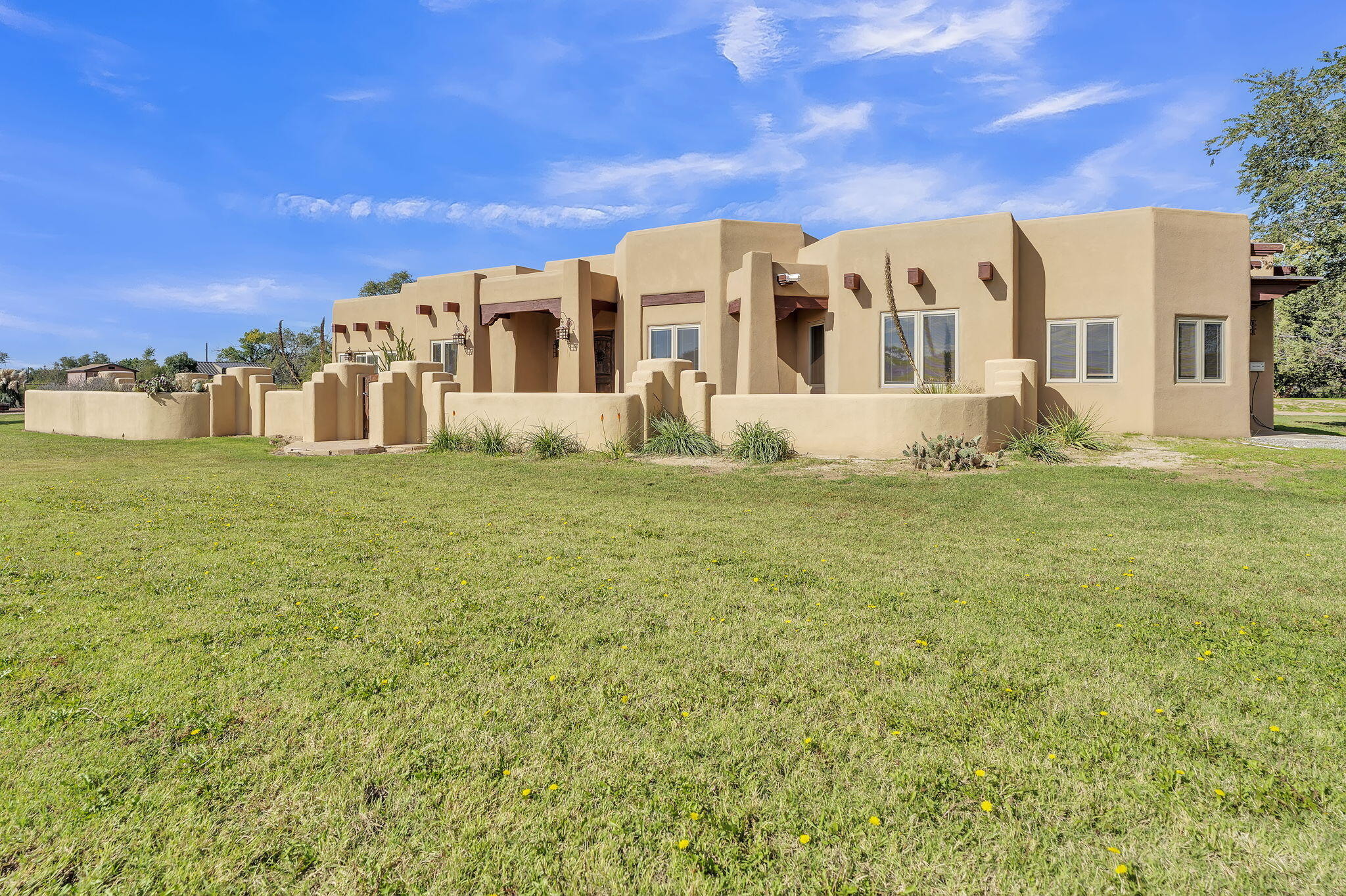 Experience the beauty of Southwestern living in this spacious, single-story Pueblo-style home situated on four irrigated acres just north Belen, in Los Chavez.  Rich in authentic architectural character, this distinctive property features plaster walls, exposed vigas, soaring ceilings, and elegant travertine flooring. The chef's kitchen showcases custom cabinetry, a 48 inch Wolf range and double door Sub Zero refrigerator/freezer and thoughtful design, while Pella casement windows and solid wood interior doors reflect the quality craftsmanship throughout.  The home offers a built-in office/library, central vacuum system, two air-conditioning units for added comfort, and a welcoming living room featuring a traditional-style Kiva gas fireplace. The spacious primary suite is a retreat of its own, complete with a unique three-way fireplace in the primary bathroom and a generous walk-in closet with a separate cedar-lined area and a separate sitting area that can be used a an exercise area or dressing room.  The property includes a 12 x 20 storage building with a rolling steel door and the TPO roof was installed in 2022.  The additional 6.46 acre parcel offers an 80 x 100 horse barn with facilities for breeding and running a complete horse operation including a one bedroom accessory dwelling unit and separate water well.  There are stalls and paddocks as well as hay barn, most of the areas have pipe fencing and cross fencing.  Multiple configurations of this offering may be available with more land.  Please see our other listings for additional options.