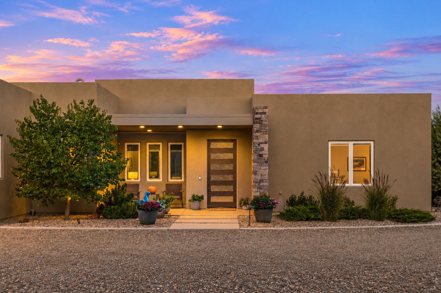 Immaculate contemporary retreat on 1.32 wooded acres in Sandia Park! Built in 2019, this stunning single-level home offers 3 bedrooms, 3 full bathrooms, a desirable split floor plan and beautiful mountain views. A dramatic great room features soaring 12-foot ceilings, a sleek fireplace and expansive windows. Enjoy a stylish kitchen, carpet-free interior, generous storage, walk-in closets in every bedroom and a primary bath with heated floors. Zero-threshold entry adds convenience. The inviting walled backyard offers a built-in gas grill, fire pit and wonderful outdoor living spaces. An oversized, heated and cooled 3-car garage adds versatility. Tucked away on a peaceful cul-de-sac near acclaimed Paa-Ko Ridge Golf Club, with dining, shopping and outdoor adventures along the scenic Turquoise Trail. Contemporary elegance meets relaxed mountain living! 3D Tour Link: https://my.matterport.com/show/?m=VgsBbPRgWqs