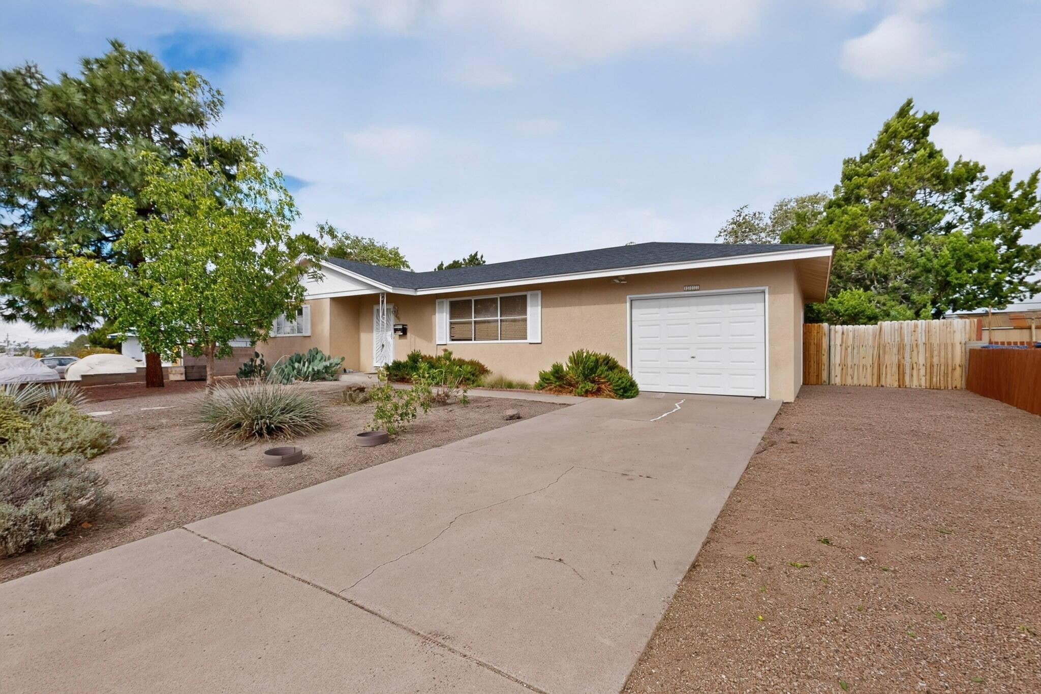 Updated 1959 Uptown ranch near San Pedro and Montgomery, with refrigerated air. The kitchen's already done: wood cabinets, solid surface counters, tiled backsplash, stainless appliances. Prior listing records also show a 2017 roof and all new plumbing underneath the home. Three bedrooms, two baths, 1,511 square feet, all on one level. The living and dining rooms both run wide and open, and there's a breakfast nook off the kitchen. Tile and wood floors, no carpet. Walled backyard. Attached garage with the laundry in it. Previous listings call it a Mossman. Easy shot to Uptown shopping, Montgomery and I-25, with Montgomery Park nearby.