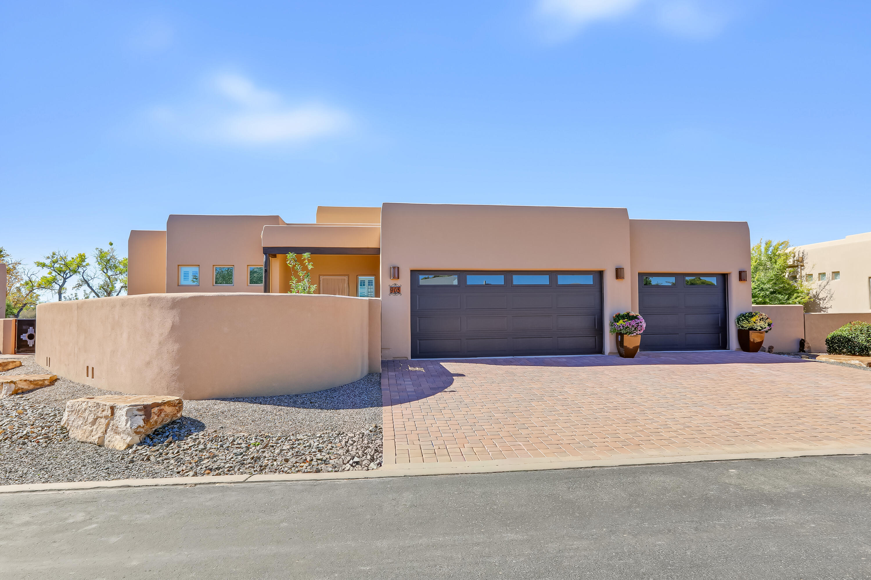 Welcome home to this beautiful custom home by Joe Boyden in the gated community of Bosque del Rio Grande, offering private access to the bosque. After you walk through the lovely courtyard, a light, bright, spacious open living area greets you, featuring exposed beams and a custom gas fireplace. The gourmet kitchen showcases cherry cabinetry, a large entertainment bar/island, granite countertops, and a walk-in pantry, creating a professional yet inviting cooking environment. From the dining room through the large open floor plan, this home is ideal for entertaining. Custom finishes include a stacked flagstone wall, chandelier,s glass tiles, updated appliances and finishes, and remote-controlled shades.The owner's suite offers elegance and relaxation at the end of the day. Enjoy dual sinks, granite countertops, glass tile accents, a large shower, and a huge walk-in closet with built-in cabinets. Outside, lovely outdoor spaces flow from the front courtyard to the backyard and covered patio. The spacious three-car garage offers plenty of storage and room for vehicles, toys, and hobbies.